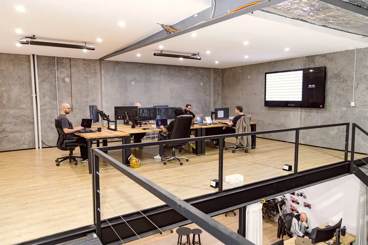 CodeFish team working at desks in a mezzanine office
