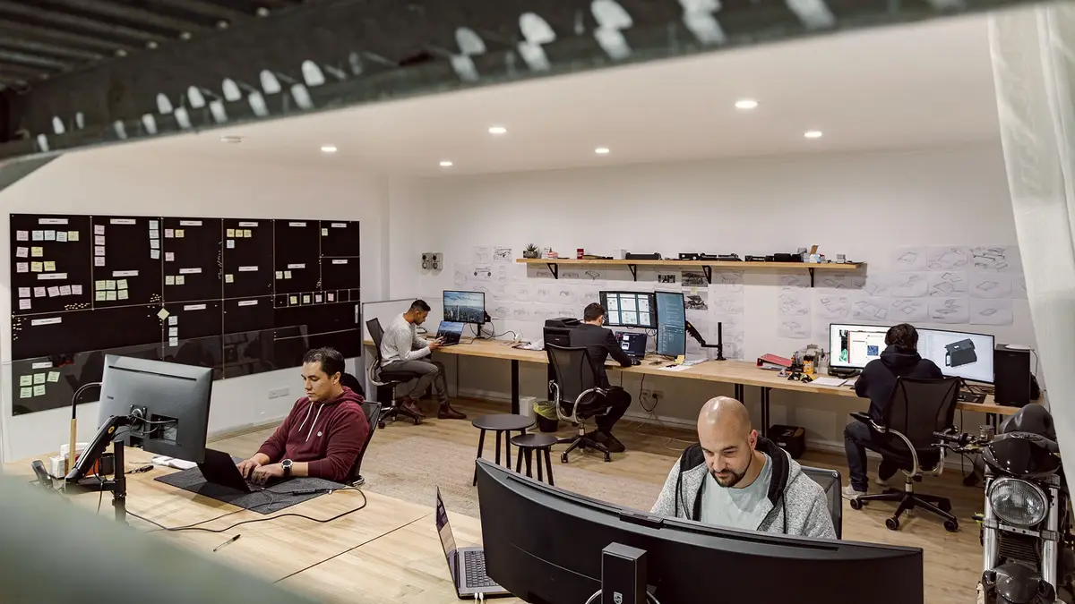CodeFish team members working at desks in an open studio office