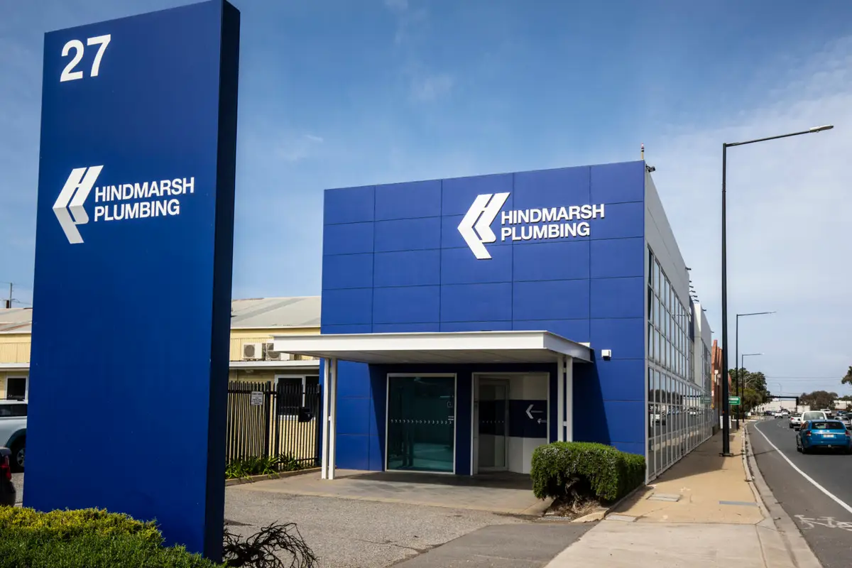 Hindmarsh Plumbing blue office building and street sign at number 27