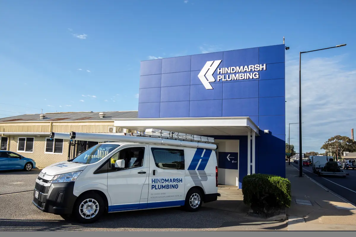 Hindmarsh Plumbing van parked outside the company's blue-clad office