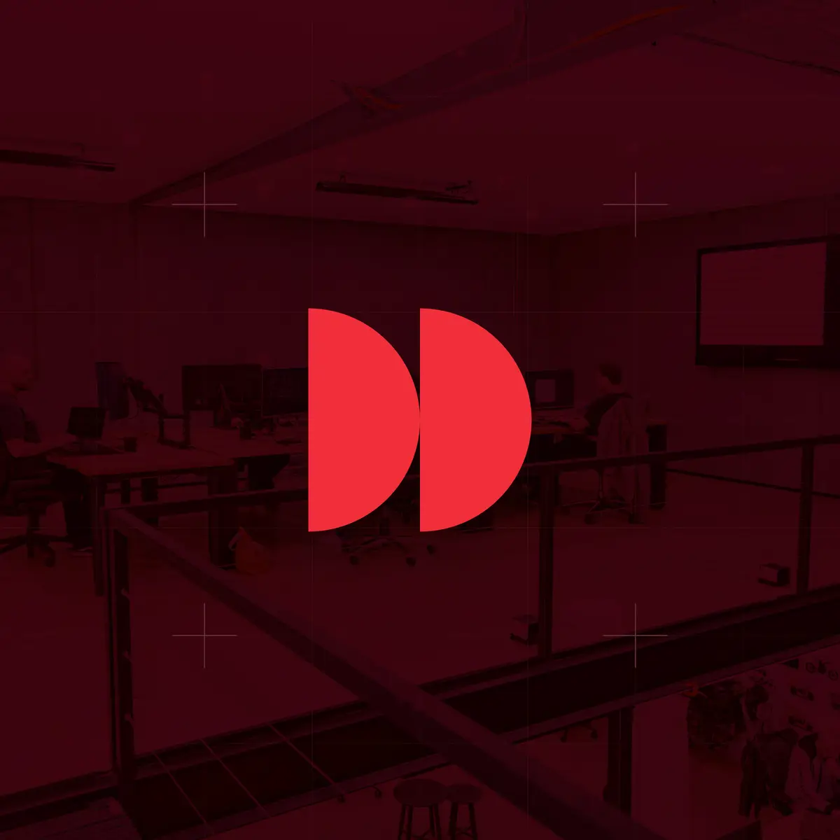 Red double half-circle icon over a dark red photo of an open plan office