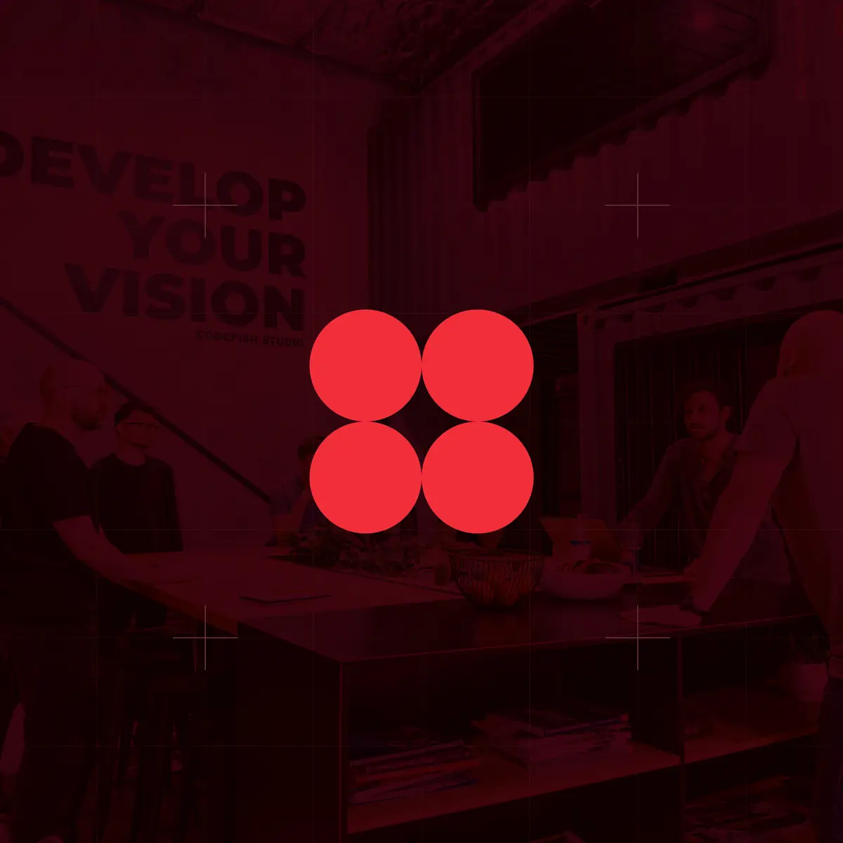 Four red circles icon over a dark red photo of a team in an office