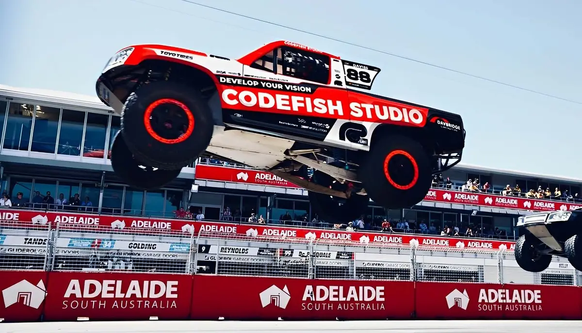 CodeFish Studio branded stadium truck airborne at an Adelaide race track