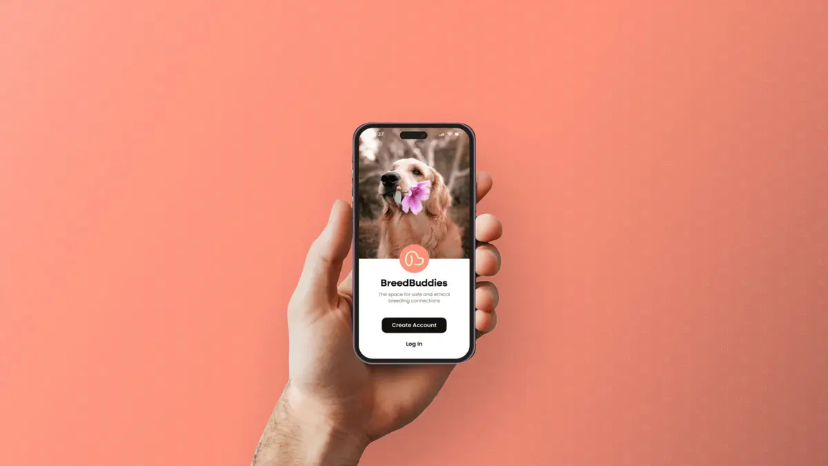 Hand holding a phone showing the BreedBuddies app sign-up screen