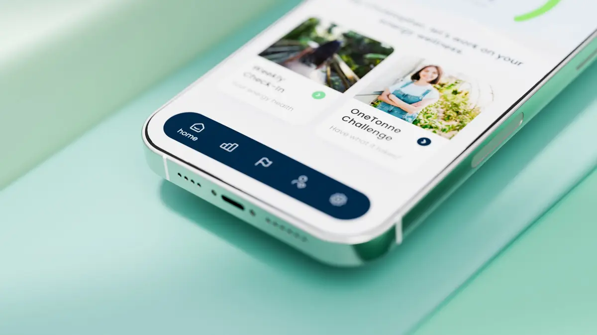 Close-up of a smartphone showing a sustainability app's home screen and navigation bar