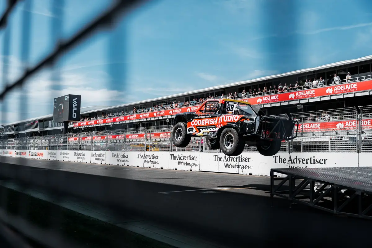 CodeFish Studio stadium truck number 88 airborne off a jump at the Adelaide street circuit