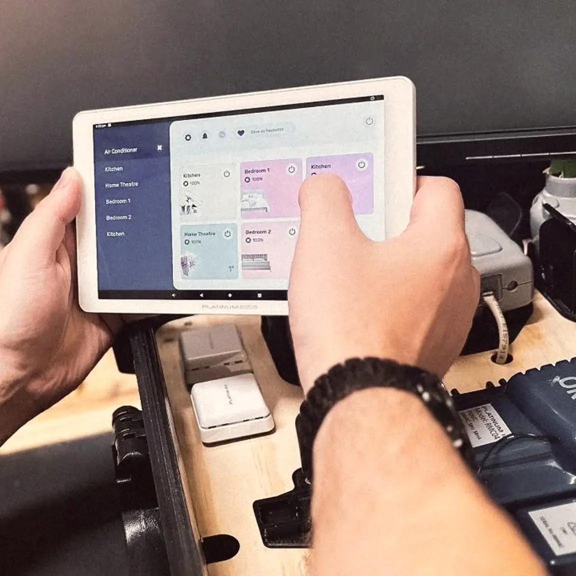 Hand using a Platinum tablet app to control home air conditioning zones