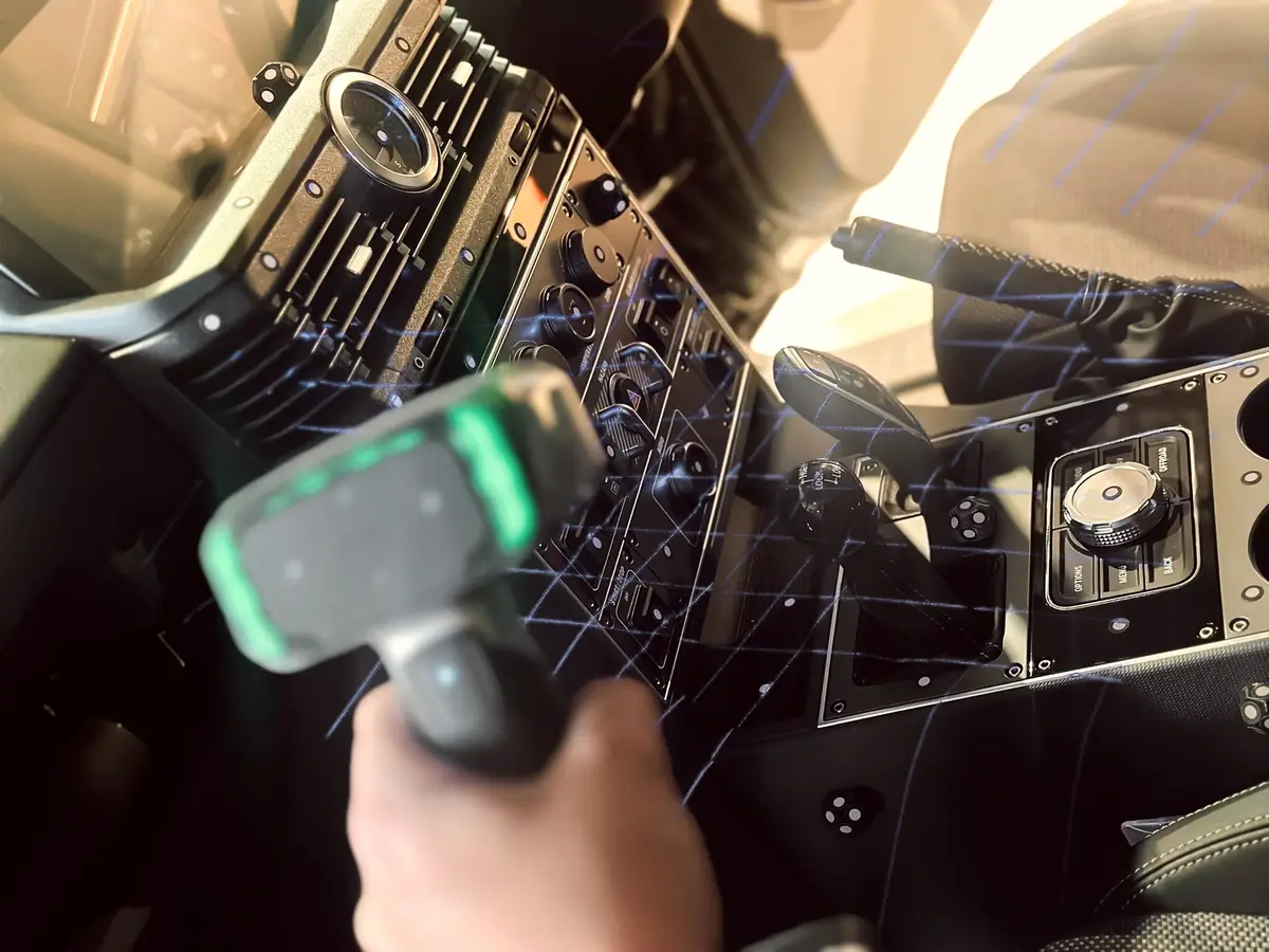 Handheld 3D scanner capturing a vehicle dashboard and centre console