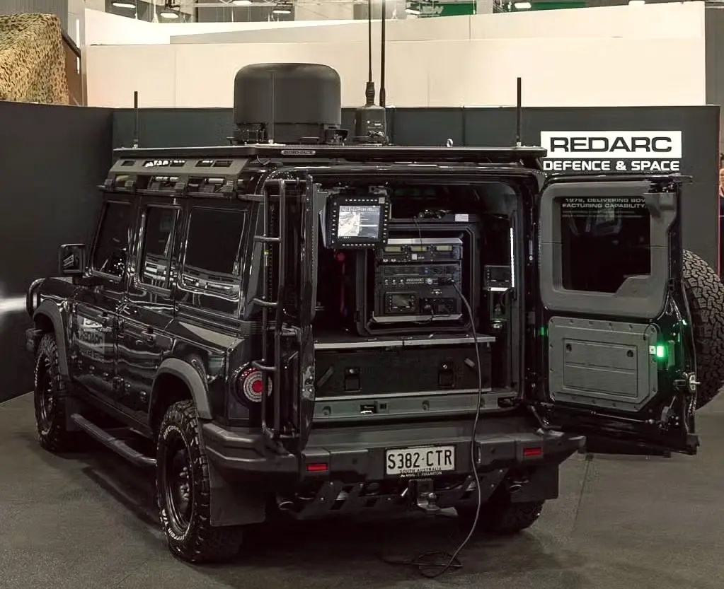 Black INEOS Grenadier fitted out with REDARC Defence and Space electronics at an expo stand