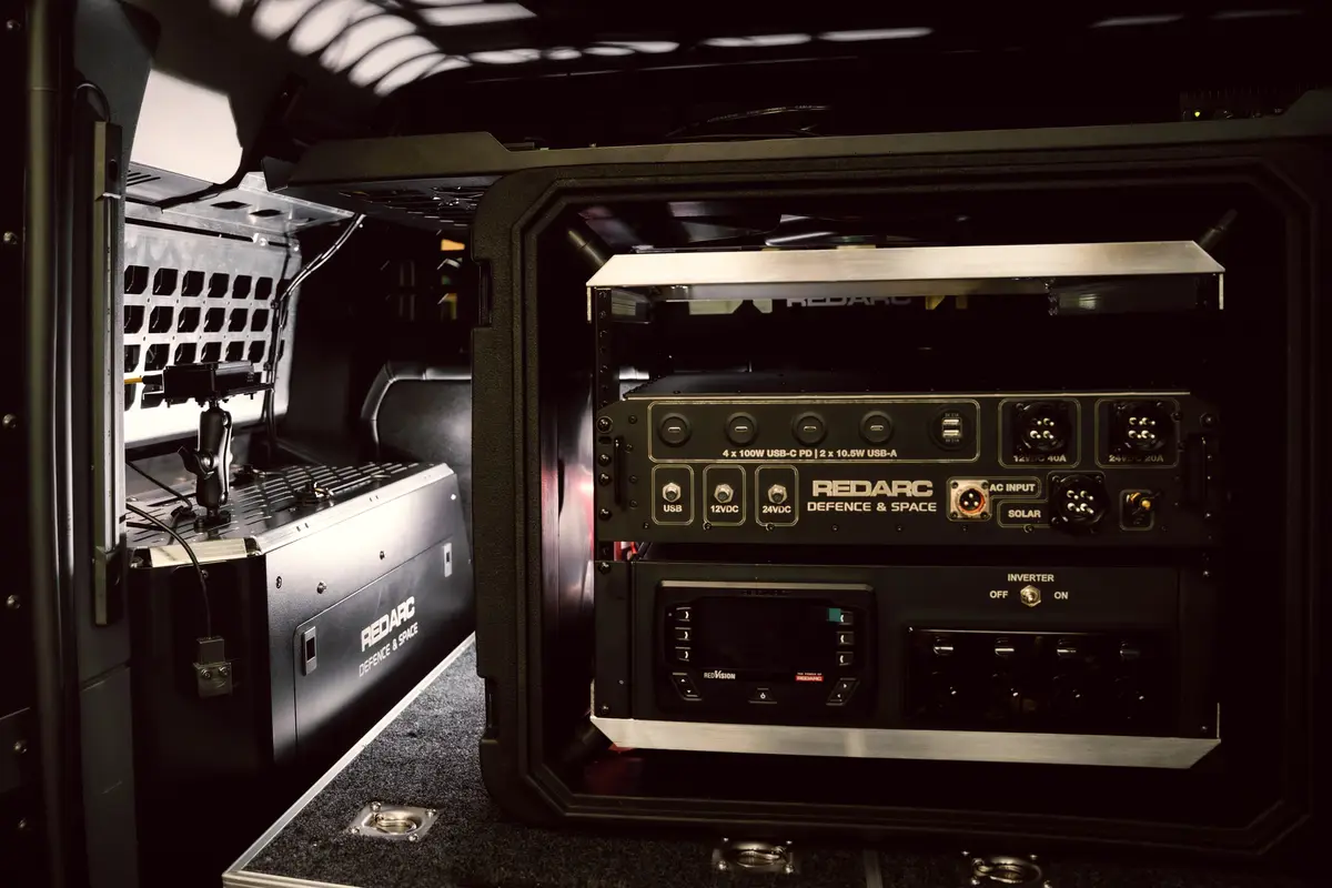 REDARC Defence & Space power rack fitted in a vehicle's rear cargo area